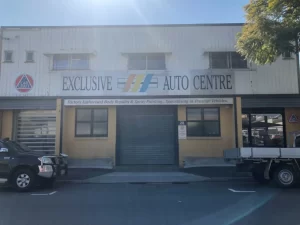 Dull-looking exclusive auto center in Brisbane with peeling paint, awaiting a vibrant transformation