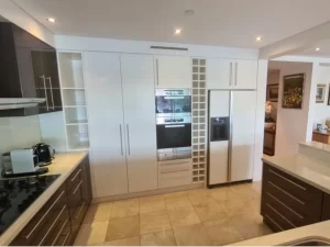 Modernized culinary space with sink, refrigerator, and microwave after a fresh paint upgrade